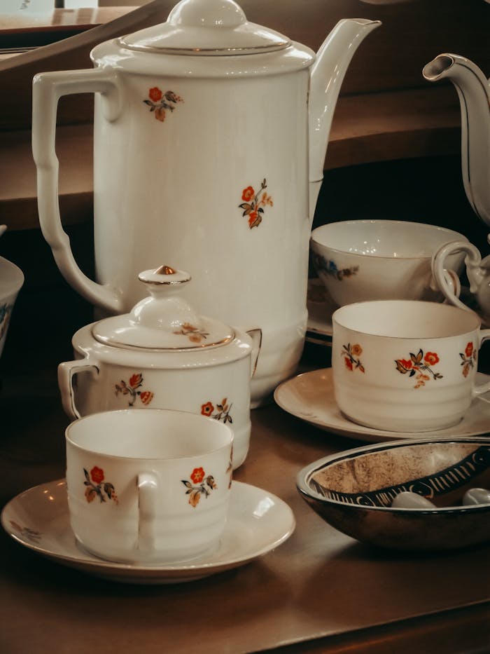 Charming vintage porcelain tea set with floral design, perfect for elegant gatherings.